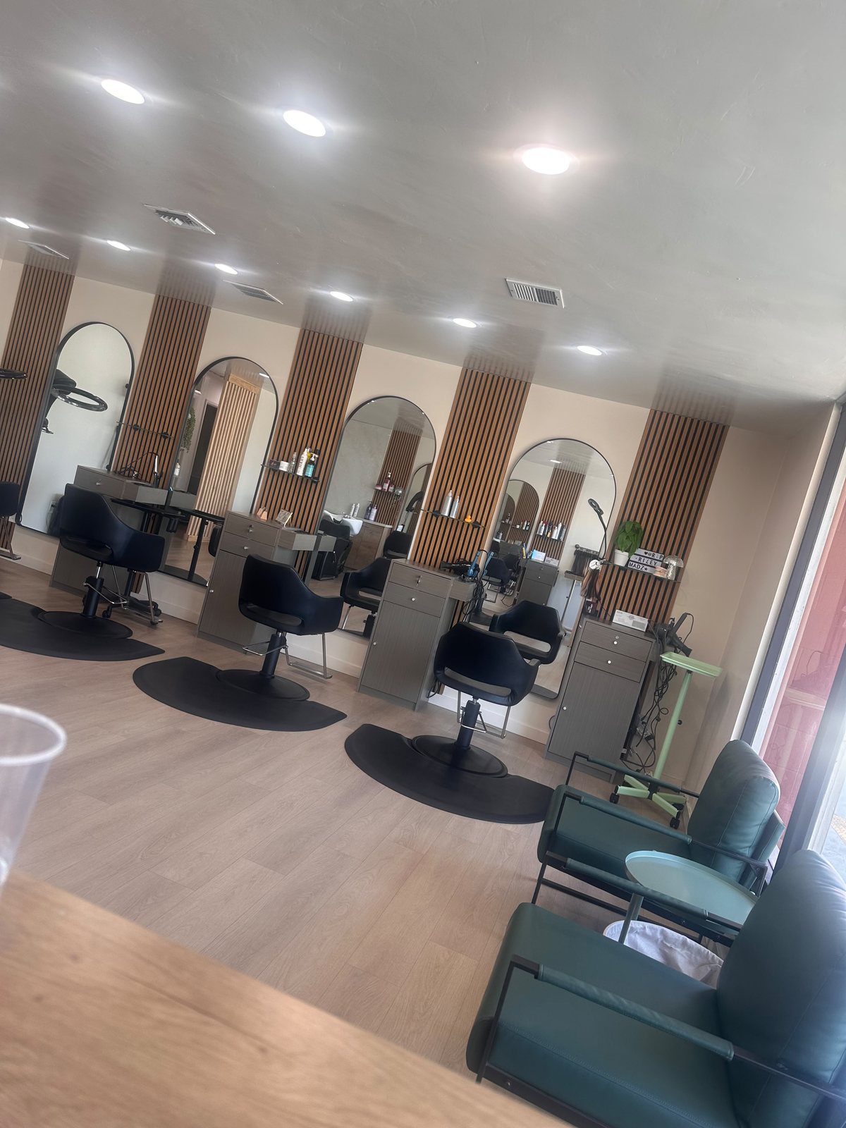 Inside Hair Palette Beauty Salon, styling stations with arched mirrors and a cozy waiting nook