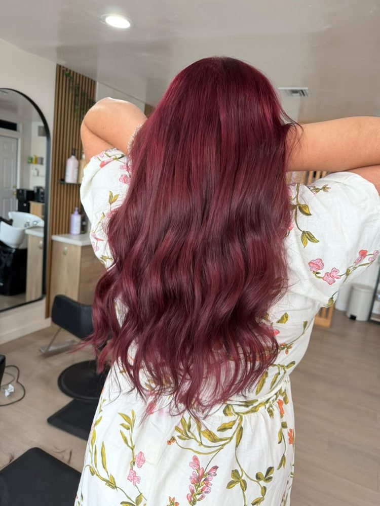 Deep cherry-burgundy red color on long, glossy waves, Hair Palette Beauty Salon, El Cajon