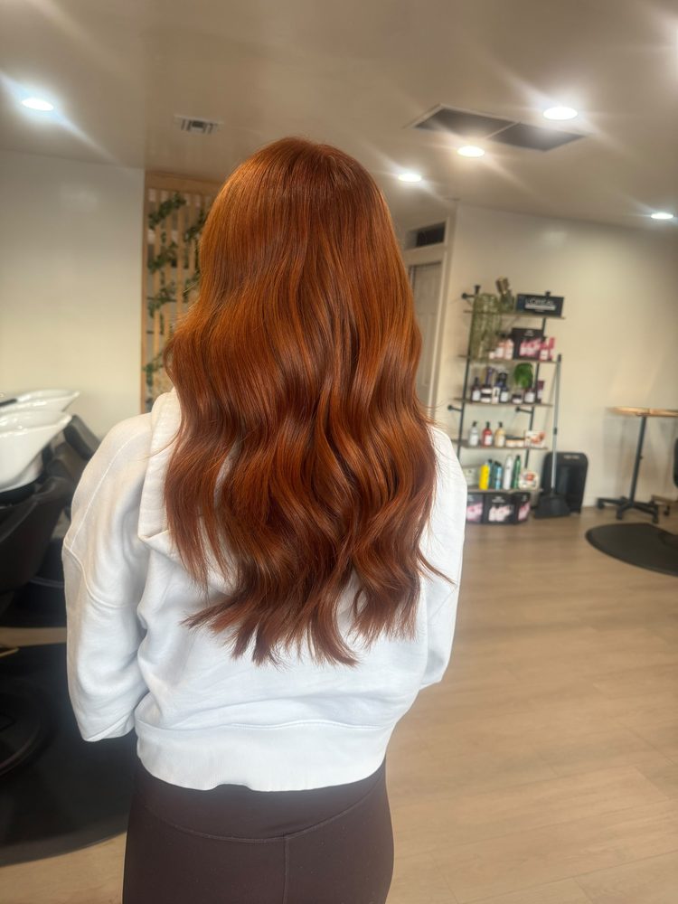 Bright copper color on long, cascading waves, rear view, Hair Palette Beauty Salon, El Cajon
