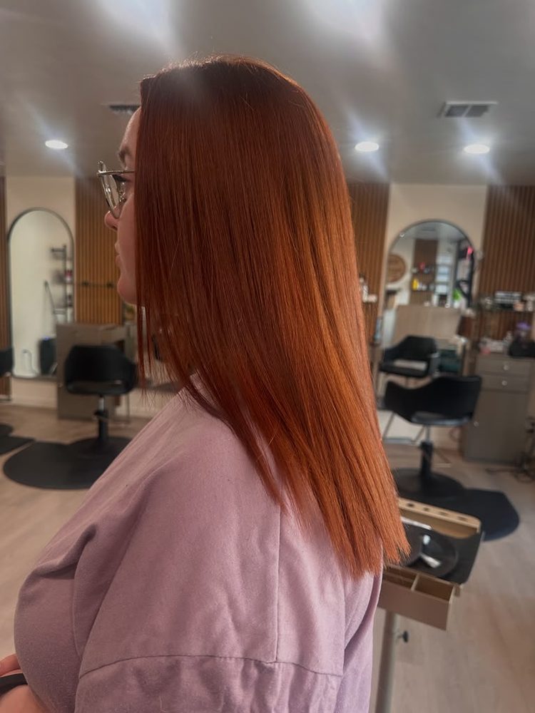 Auburn-copper color on a sleek, straight mid-length style, side view, Hair Palette Beauty Salon, El Cajon