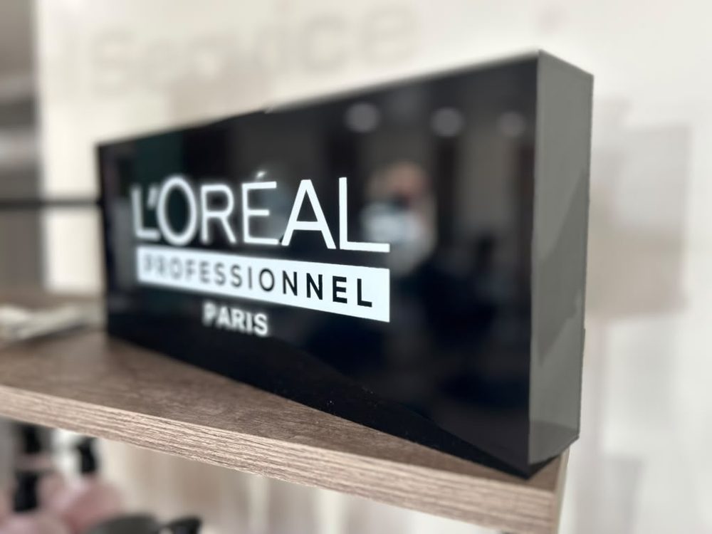 L’Oréal Professionnel Paris display sign on the retail shelf at Hair Palette Beauty Salon in El Cajon