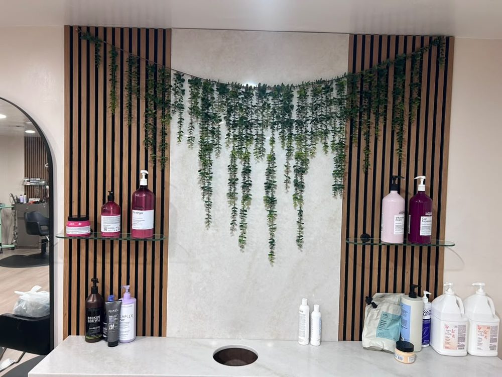 Wash station wall with L’Oréal Professionnel Paris and other professional hair products at Hair Palette Beauty Salon in El Cajon