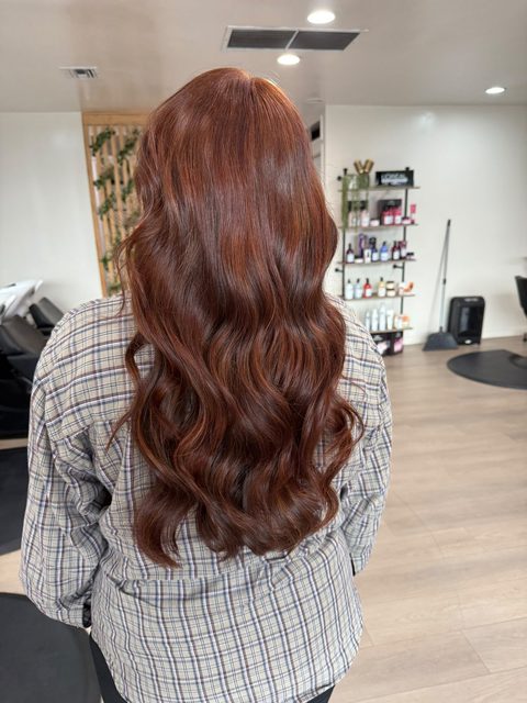 Rich auburn-copper color on long, voluminous waves
